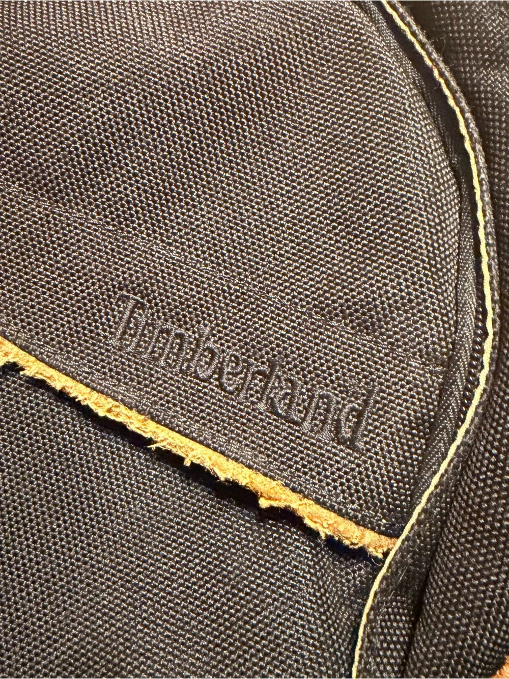 Timberland Black Sling Backpack with Brown Leather Accents